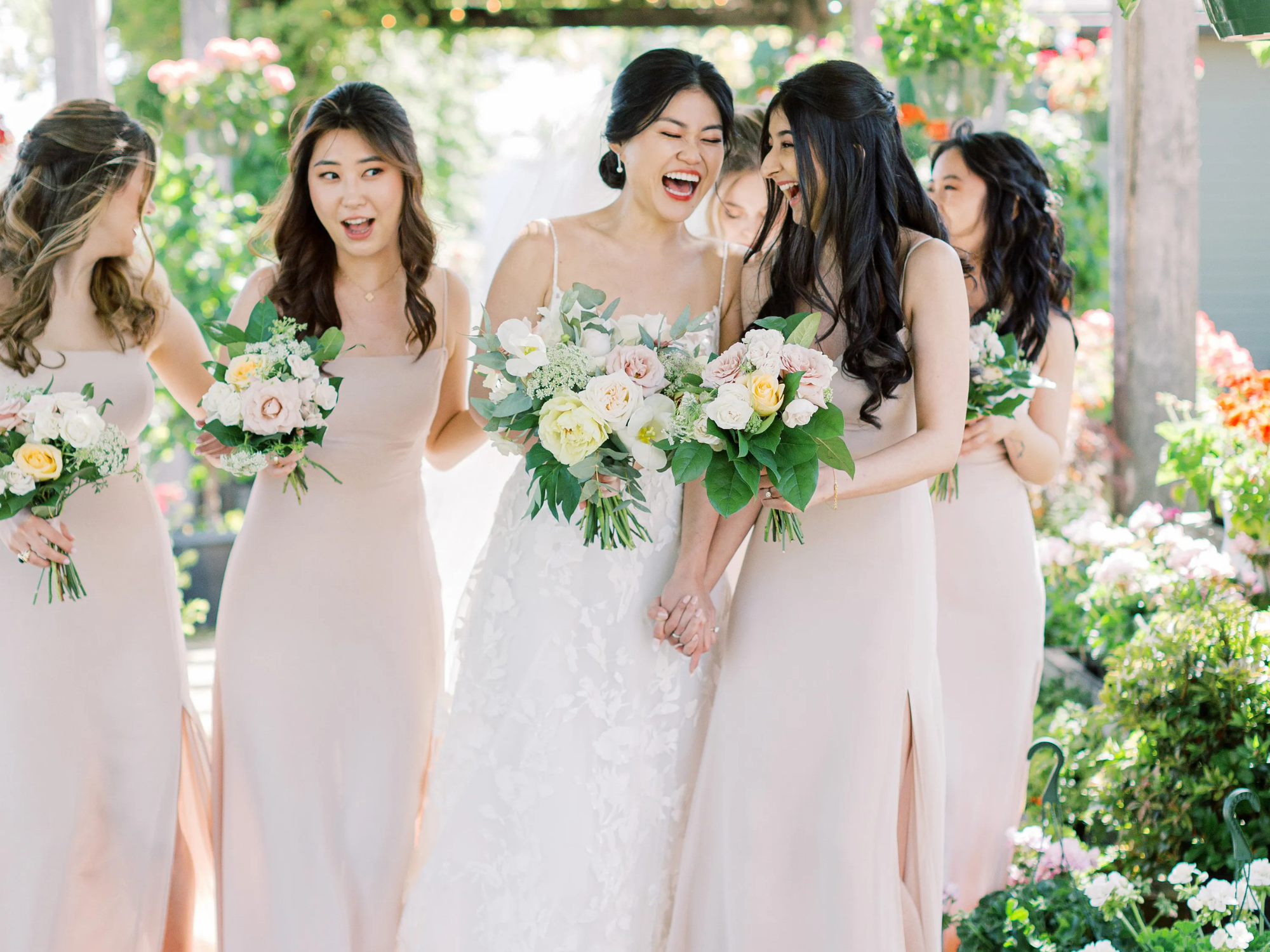 Bride laughing with bridesmaids