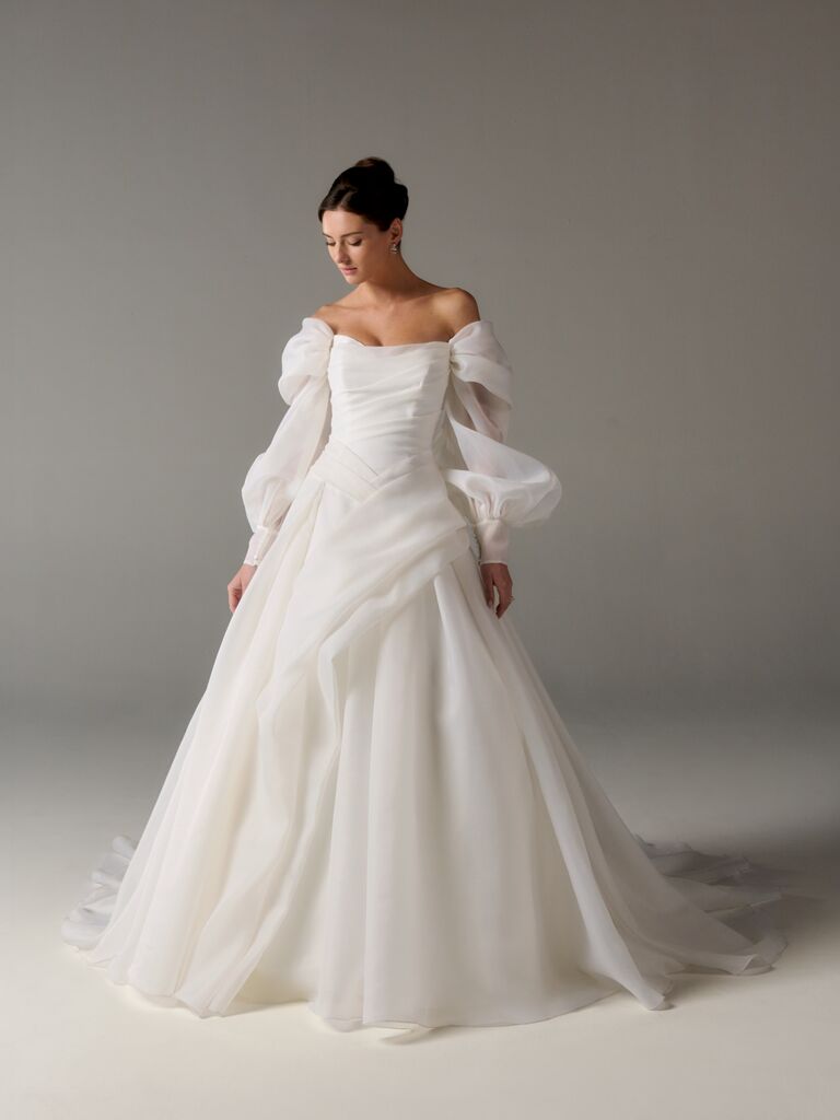 Off-the-shoulder long-sleeve wedding dress with airy fabric and asymmetrical draped skirt