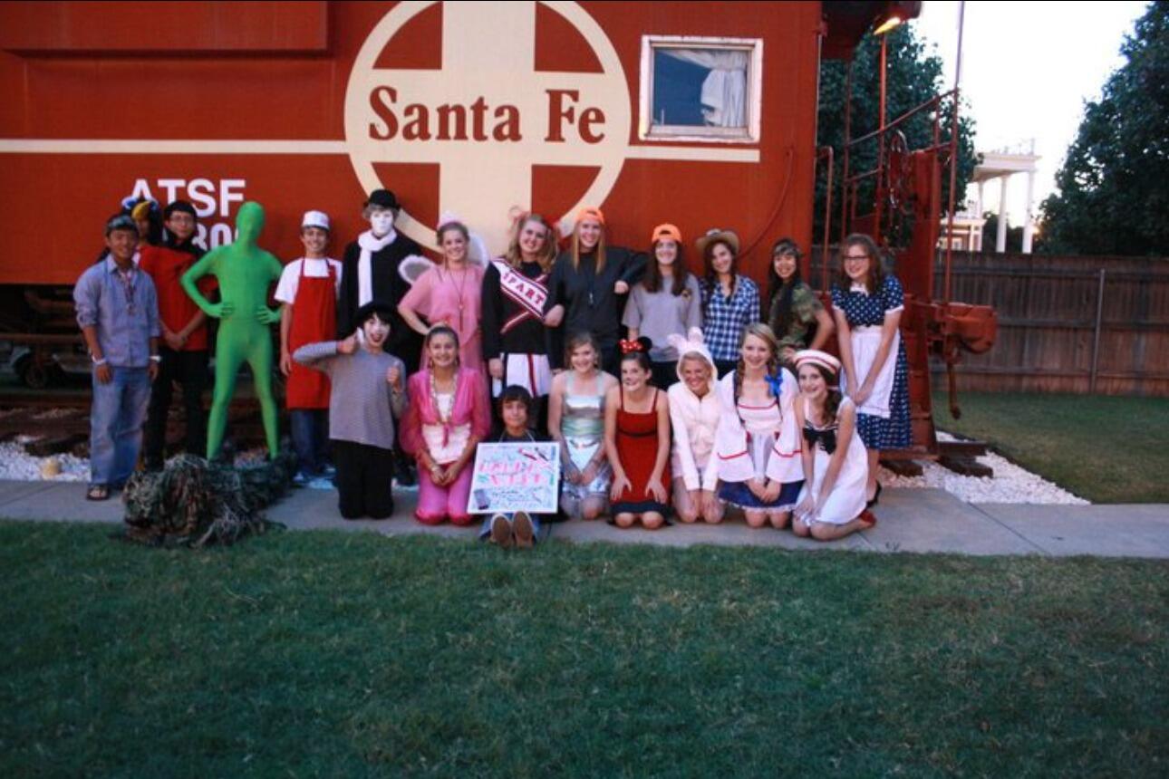 John and Savanna maintain their friendship all through their High School years, participating in school events and joining each other at celebrations. (John on the far left dressed as a 'hippie' and Savanna front row and center dressed as a 'disco ball').