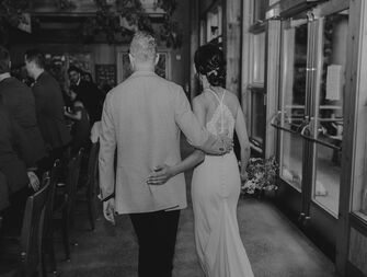 Couple entering reception on their wedding day.