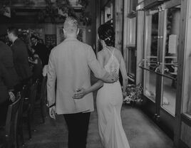 Couple entering reception on their wedding day.