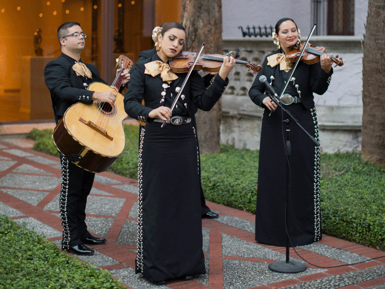 Mariachi band playing at a wedding outside. 