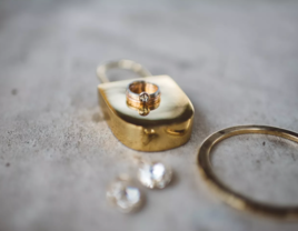 Gold male engagement ring on gold lock