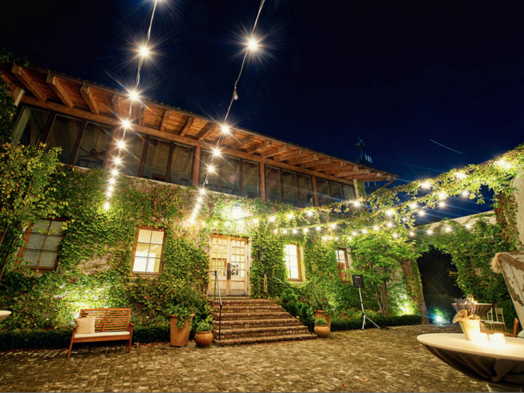 Outside view of wedding venue with hanging bistro lights