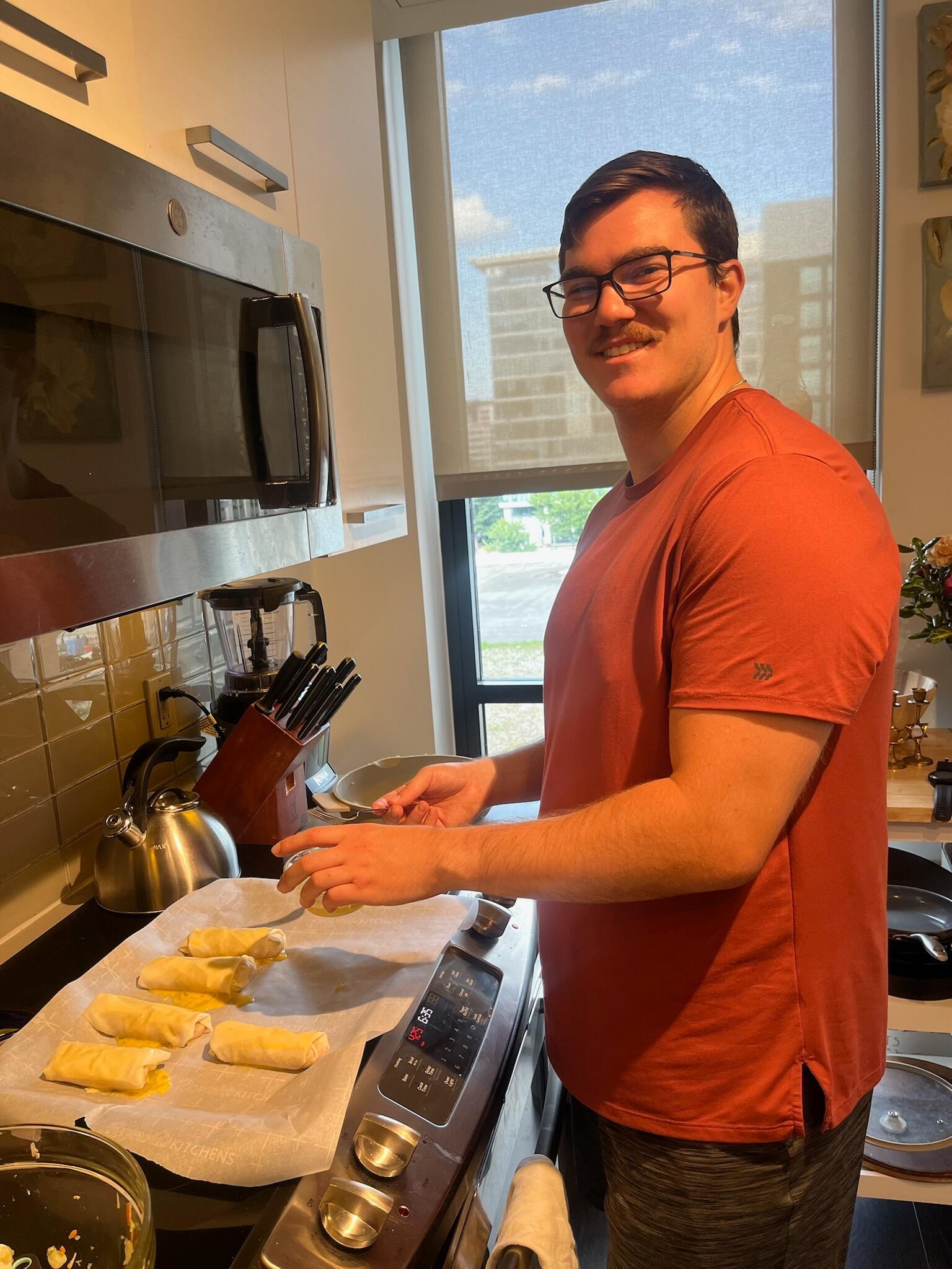 Josh using his culinary skills to make homemade egg rolls