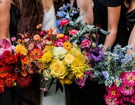 Bride and bridesmaids with rainbow bouquets