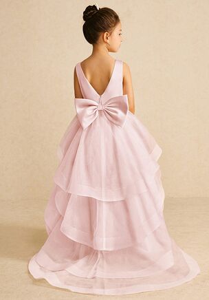 We encourage all our flower girls to feel like the princess they are while wearing Pumpkin. Made from matte satin and tulle, she features a scoop neckline, a bow tie belt, a ruched A-line silhouette, and a tiered tulle skirt trimmed with horsehair. This dress is not only perfect for a flower girl at a wedding but also versatile enough for other special occasions.