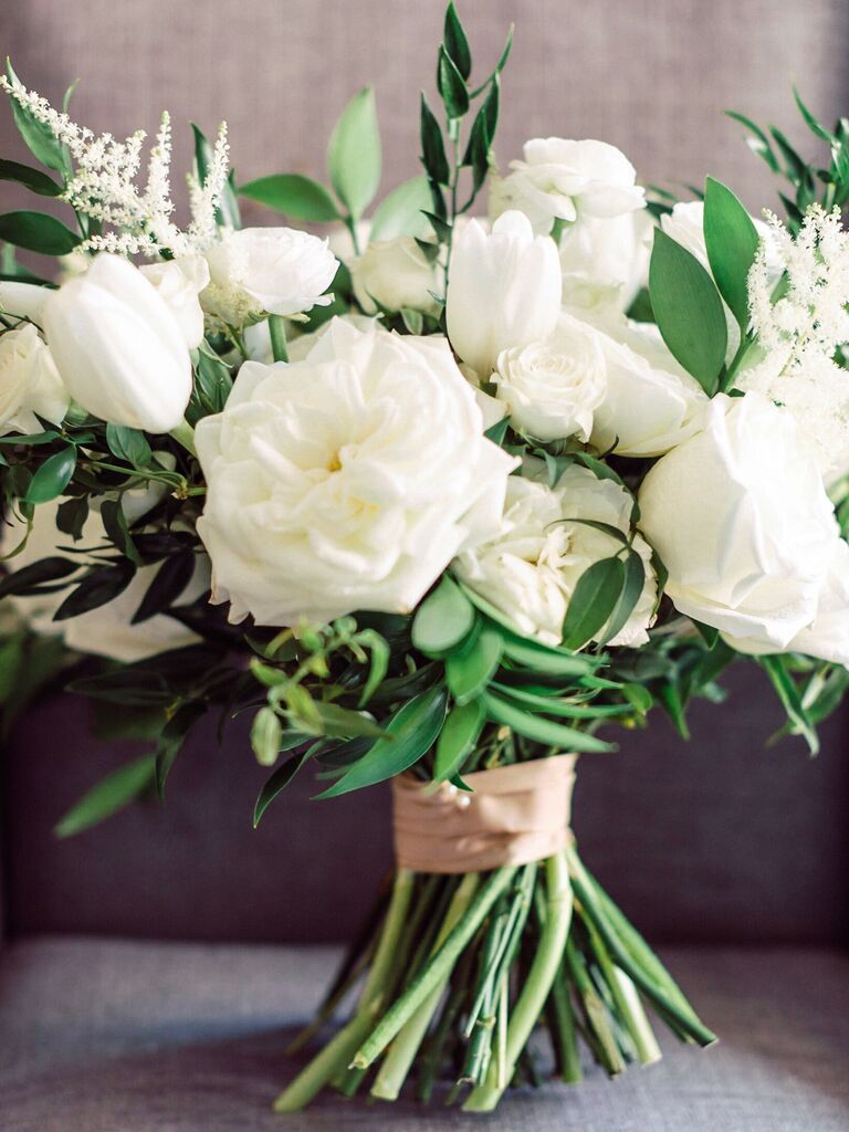 classic wedding bouquet with white roses, tulips, astilbe and greenery with stems wrapped in blush ribbon