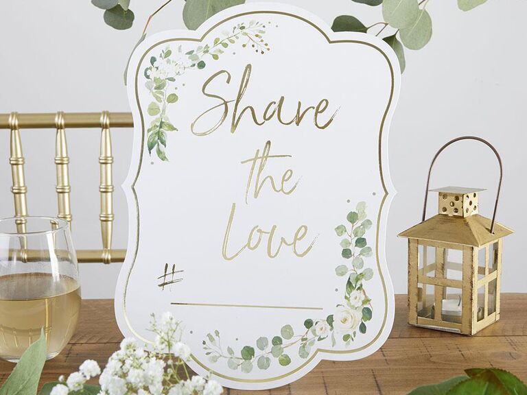'Share the love' in gold script with greenery design and gilded gold border