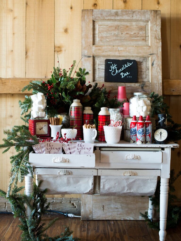 Rustic hot chocolate bar featuring delicious toppings, such as whipped cream, candy canes, and marshmallows. 