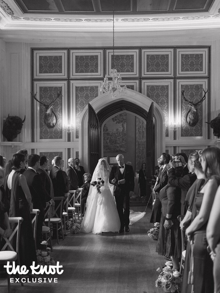 Logan Rae Hill walking down the aisle with her dad during her wedding ceremony