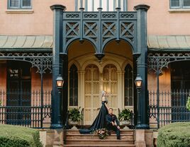 Couple wears elegant black wedding attire. 