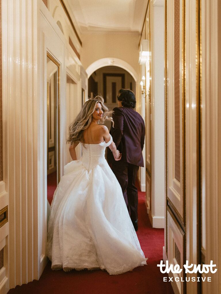 Logan Rae Hill and Joey Kurbanov holding hands and running through their wedding venue