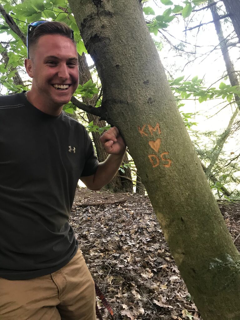 Kyle carves our initials into a tree in Rushford, NY!