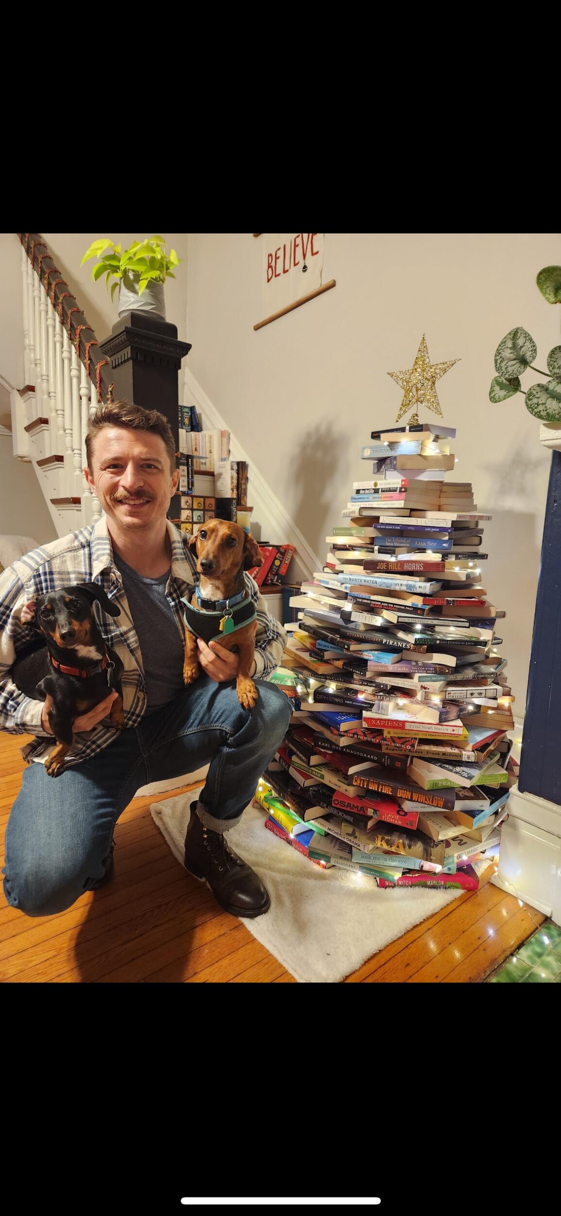 Micah with the famous Christmas book tree! 