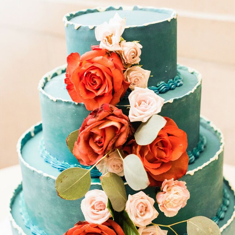 Four-tier teal cake with fresh red roses