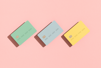 Three credit cards on pink background, does getting married affect your credit score