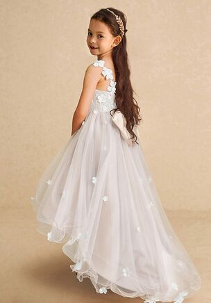 Let your little one shine in the Celia dress, where playful charm meets elegant design. The dress boasts a captivating asymmetrical silhouette with a knee-length front and cathedral-length back, complemented by a sleeveless V-neckline. Adorned with 3D flowers and a lovely bow at the back, its tulle over lace bodice and A-line skirt promise a magical look for any flower girl. This dress is not only perfect for a flower girl at a wedding but also versatile enough for other special occasions.