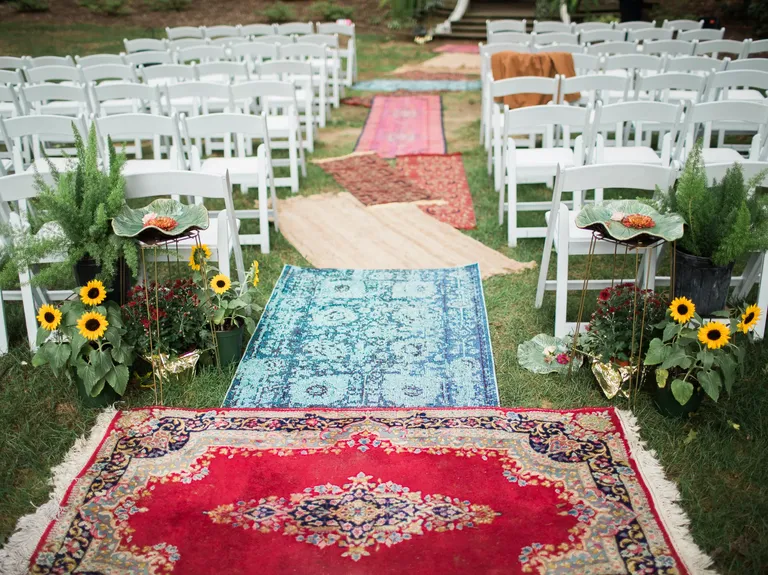 Bohemian rug aisle runners at a backyard wedding