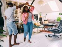 Couple dancing together at home