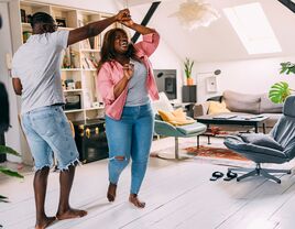 Couple dancing together at home