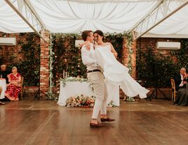 Groom lifting his bride on the dance floor during their first dance