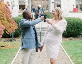 A bride and groom toast themselves on their wedding day