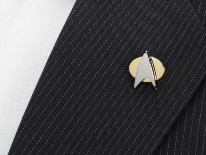 A gold and silver Star Trek Delta Shield worn on a suit from Cufflinks.com