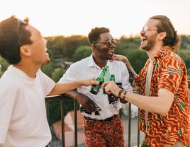 A groom celebrates with two of his best friends.