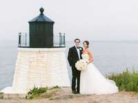 wedding couple standing with lighthouse