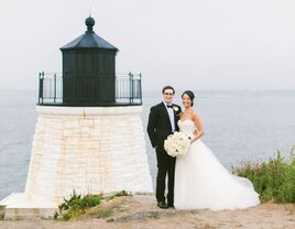 wedding couple standing with lighthouse