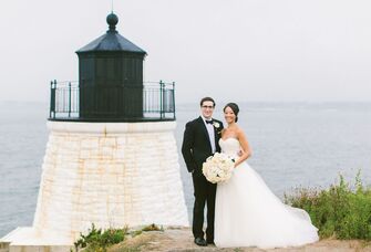 wedding couple standing with lighthouse