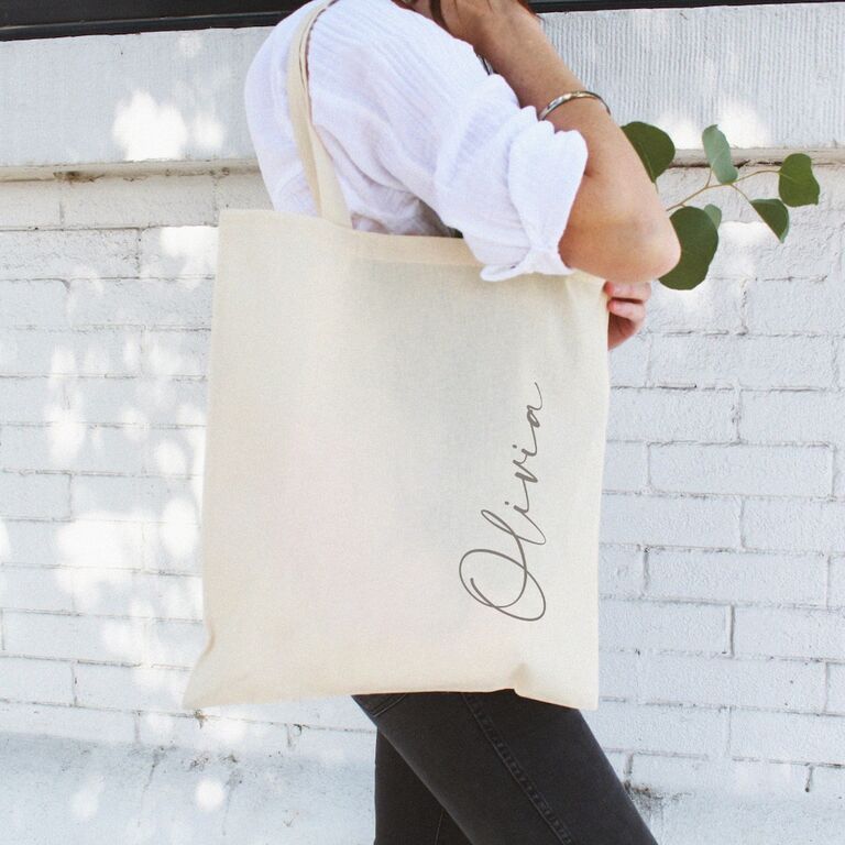 Woman using her beige personalized tote bag
