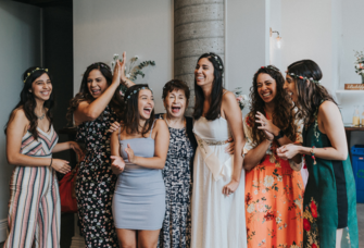 women smiling and laughing together at bridal shower