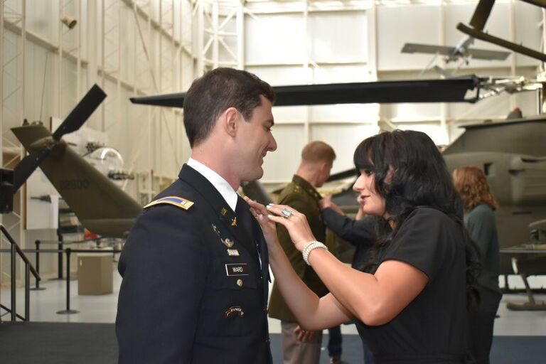 Josh received Silver Wings for being the Distinguished Honor Grad. McKenzie pinning the Wings on Josh. 