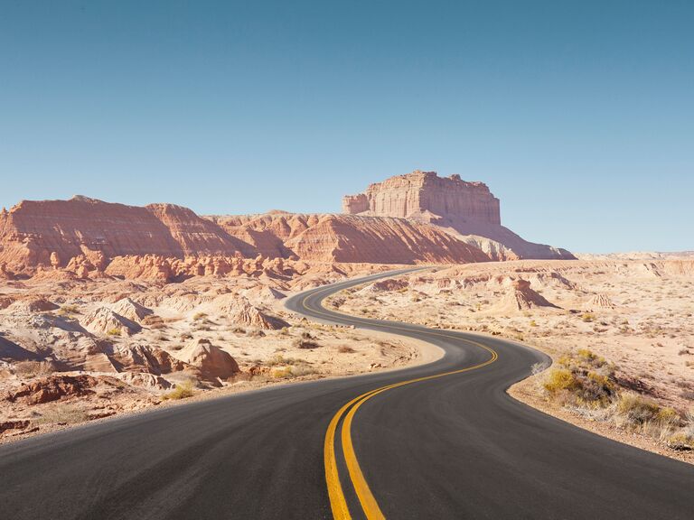 Winding empty road through arid desert landscape