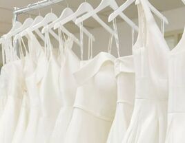 White bridal gowns hanging on dress rack in B.B. Studios bridal shop in Boise, Idaho