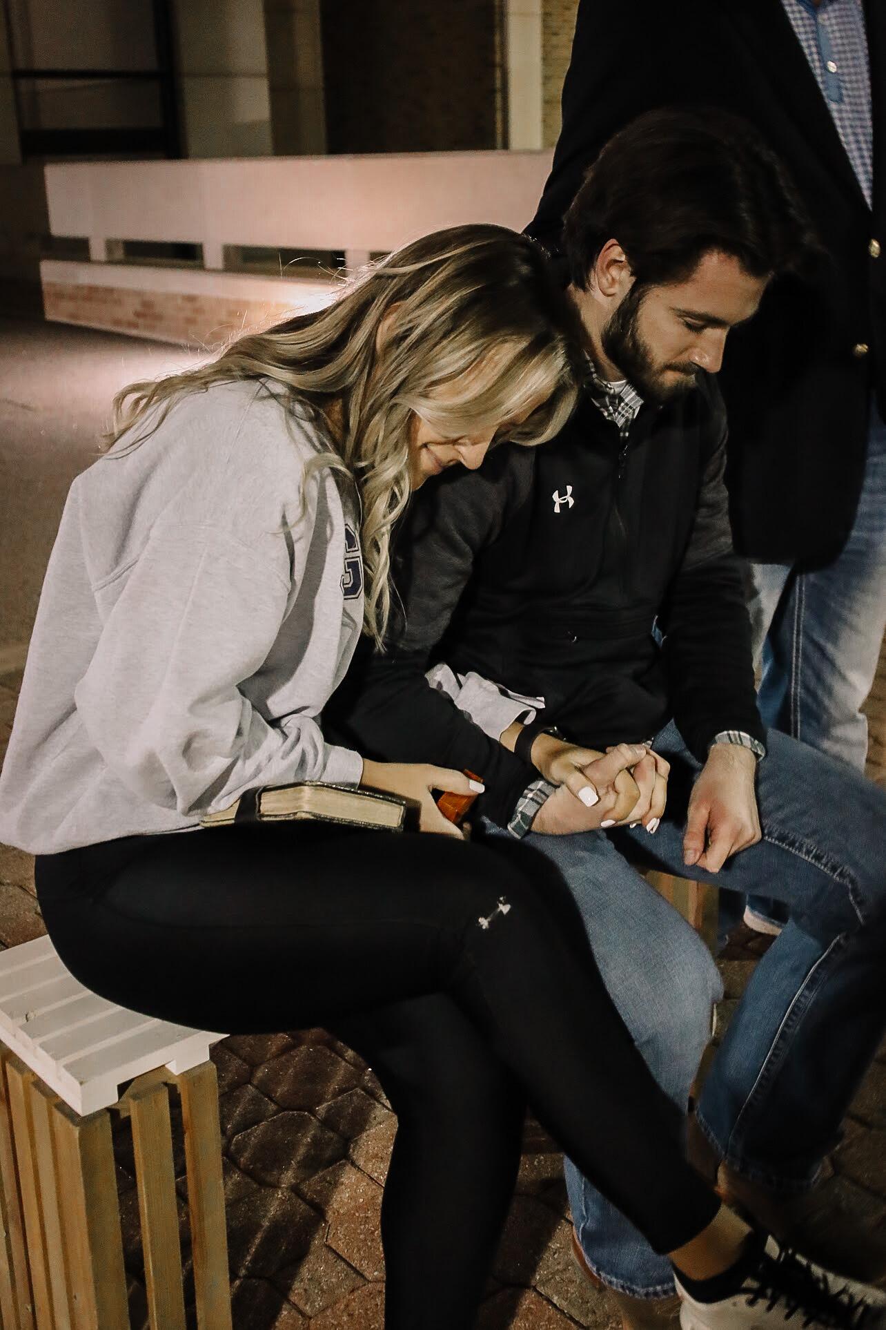 Brock and Ashlynn being prayed over the night of their proposal at Ashlynn's sorority engagement celebration