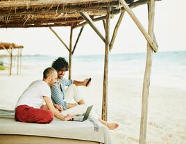 Two people looking at a map with computer.