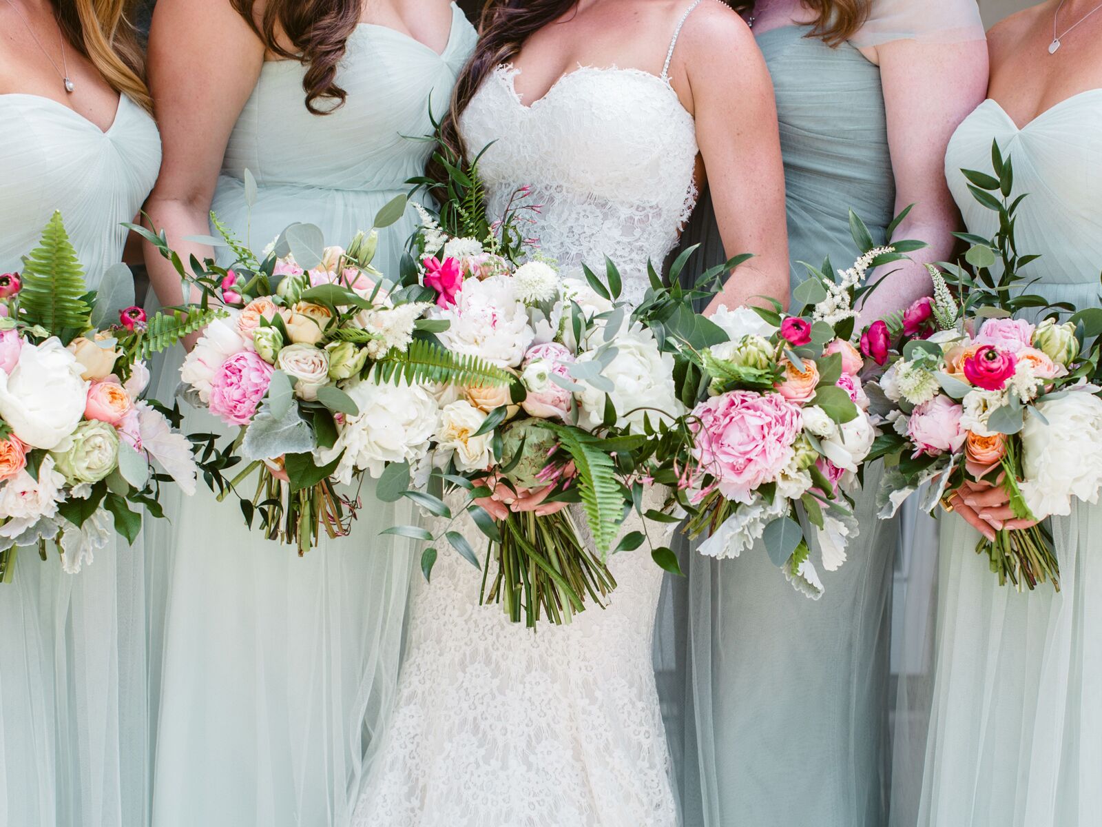 Bride with bridesmaids holding bouquets
