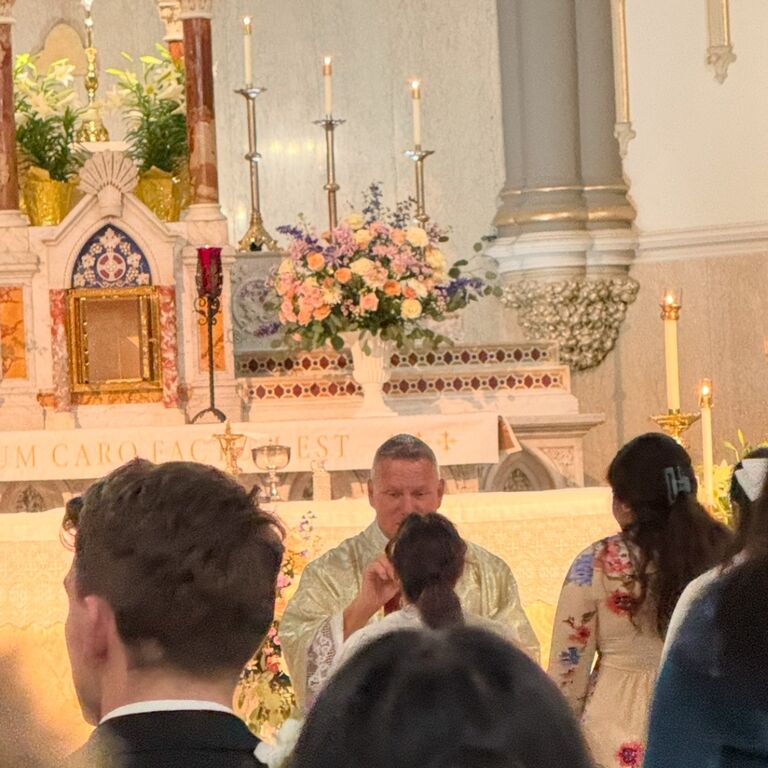 Mikayla receives the Eucharist (the body, blood, soul, and divinity of God) for the first time