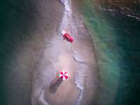 couple on kayak and beach umbrella on sand bar for a honeymoon ideas