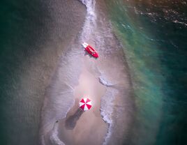 couple on kayak and beach umbrella on sand bar for a honeymoon ideas