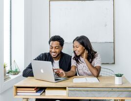 Engaged couple learning how to make wedding registry