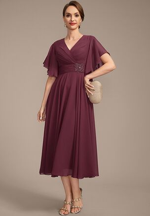 This stunning dress is crafted from chiffon, featuring a flattering V-neckline with soft flutter sleeves. The waist has delicate beading detailing for an added touch of sophistication. The flowing A-line skirt offers effortless movement, making this dress a perfect choice for any formal occasion.
