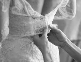 Bride gets ready for wedding day. Wedding dress sizing. 