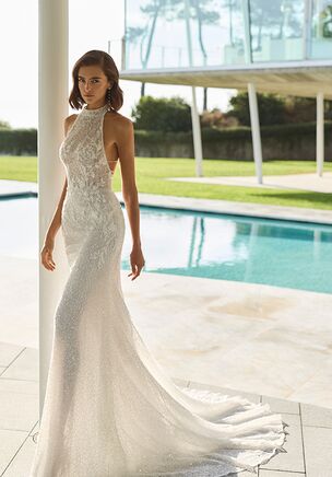 Mermaid silhouette wedding dress in lace with halter neckline, beading and cross-back straps