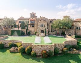 Outside view of the grand stone venue of The Club at Bella Collina