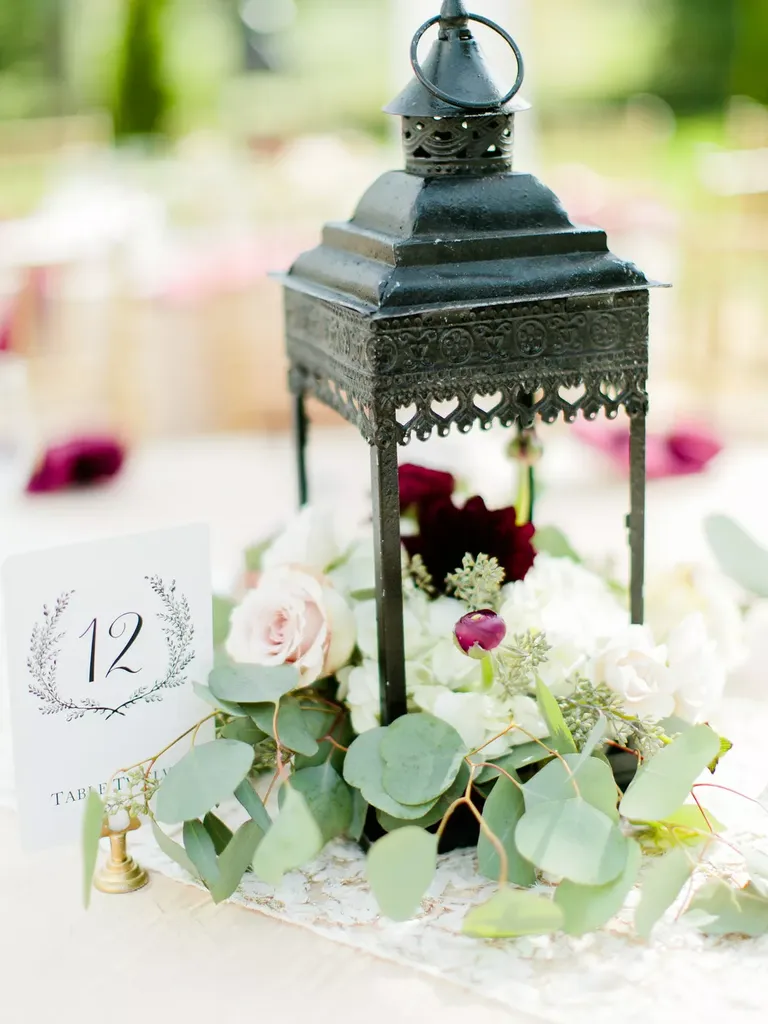 Greenery, Lanterns and Table Numbers on Dining Tables