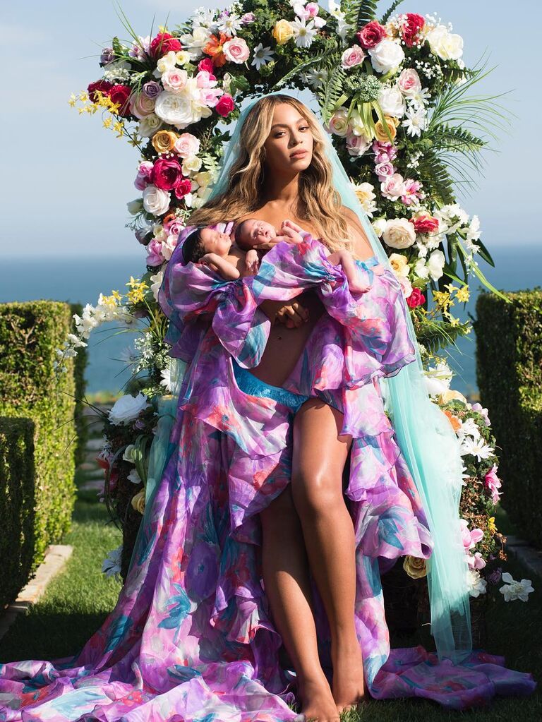 Beyonce holds newborn twins Rumi and Sir in a whimsical photo shoot. 